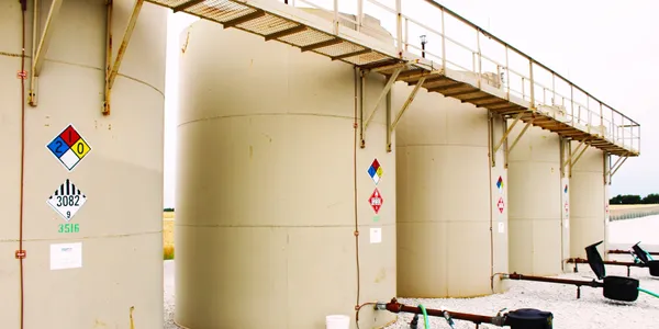 A large white tank sitting next to a building.