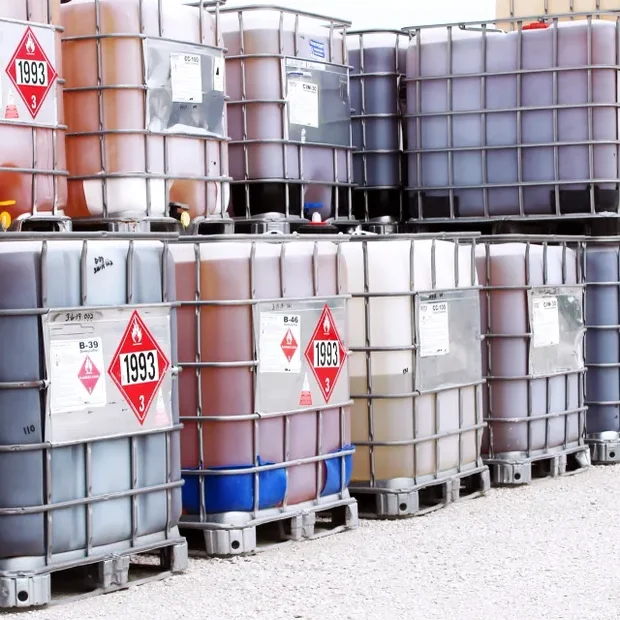 A group of barrels sitting on top of pallets.